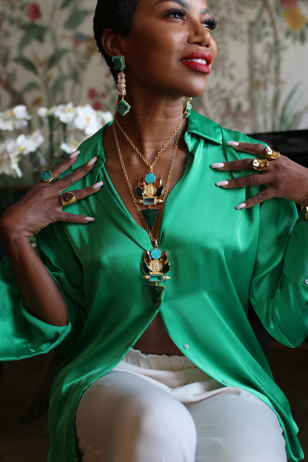 These eye-catching drop earrings will bring a burst of color and life into your jewelry collection. These chandelier earrings feature freshwater pearl and green agate that have wonderful movement, and are caged in 22k gold brass detailing.