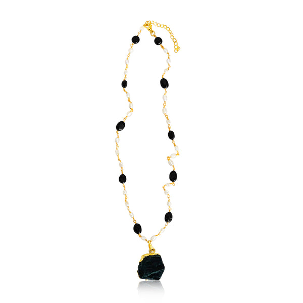 A beautiful hand made necklace. This gold plated pendant necklace for women comes with pearls and black onyx.  Product Details  Composition: 22k gold-plated brass, onyx, fresh water pearls 18 inches with 3 inch extender  Handmade in Morocco Please note the possibility of natural inclusions in gemstones