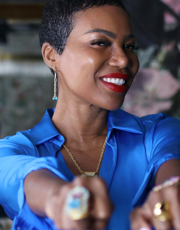 These stunning topaz drop earrings will bring a burst of color and life into your jewelry collection. These drop earrings feature a 22k gold brass chained link that drop into a dark blue topaz stone. 