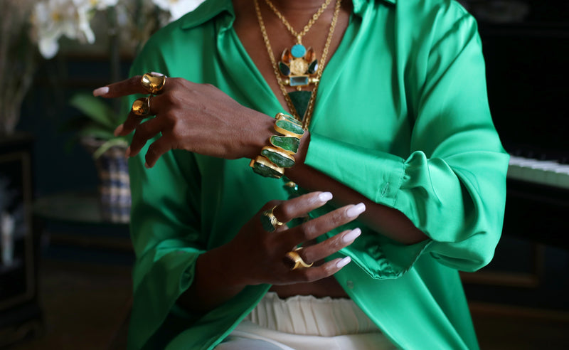 Handmade from 22k gold-plated brass, the 'Green Agate' cuff features a sculpturally inspired silhouette adorned with beautiful vibrant precious stones.