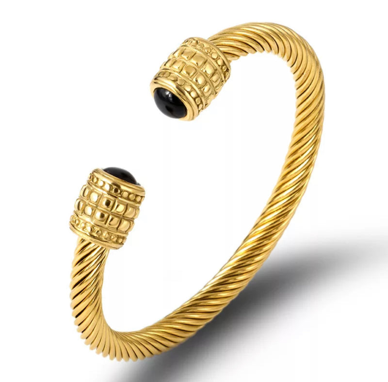 Cable wire twisted bangle.  Material: 18 karat gold plated stainless steel.  How To Care For Your Jewelry:   Jewelry made with brass and silver will naturally oxidize over time, developing a beautiful patina that some collectors prize. To restore your jewelry piece's original shine, clean it with the soft cloth that came in with your order.