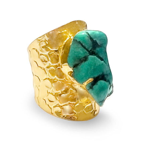 This adjustable statement ring is crafted in 22k gold brass and features a large natural round shape made of turquoise stone.  Product Details  Composition: 22k gold-plated brass, turquoise stone Adjustable Handmade in Morocco Please note the possibility of natural inclusions in gemstones                     (See pictures below)